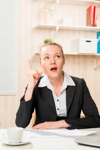 Thoughtful business woman in suit in the office