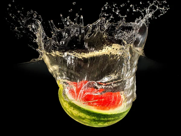 Fresh melon falling in water with splash on black background