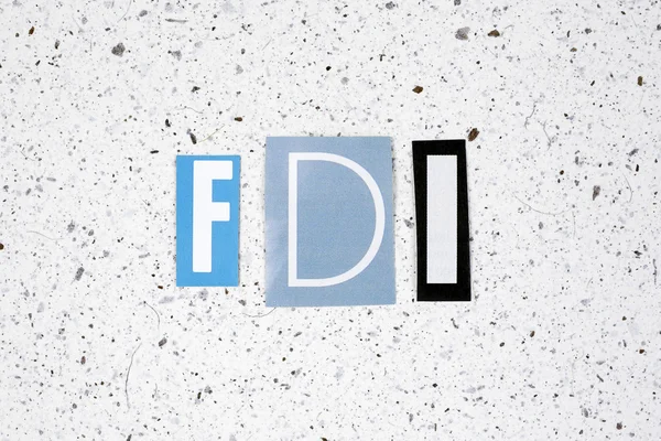 FDI (Foreign Direct Investment) acronym on handmade paper texture