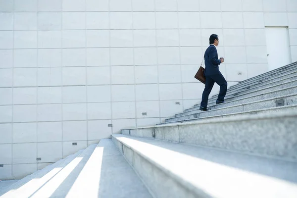 Businessman walking up the stairs
