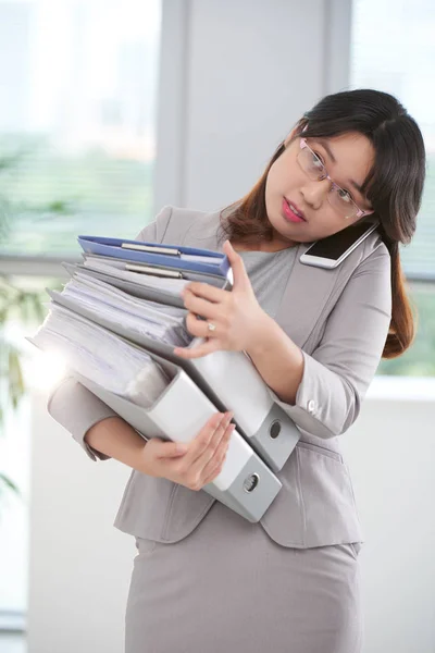 Business lady with big stack of folders