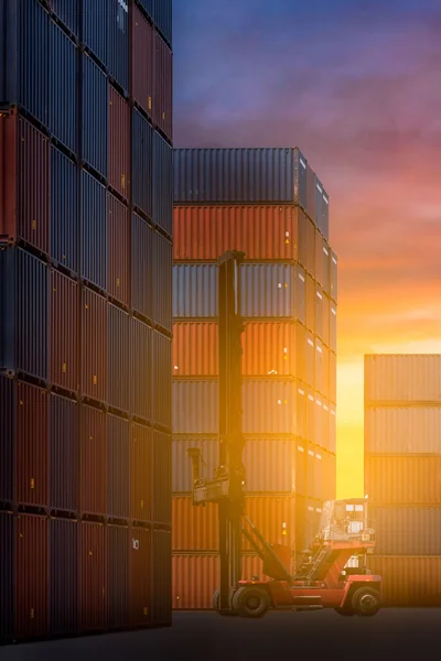 Orklift truck in shipping yard or dock yard against sunrise sky