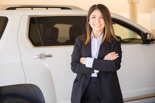 Woman in a suit selling car