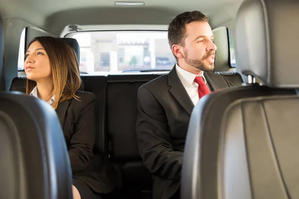 Businesspeople traveling together by car