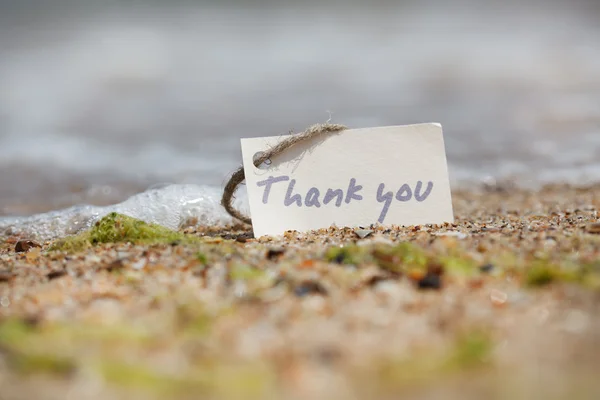 Thank you - sign on the beach