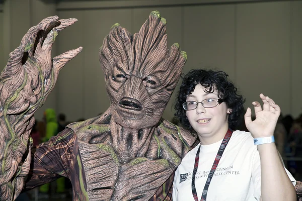 Person wearing Groot costume with boy at NY Comic Con