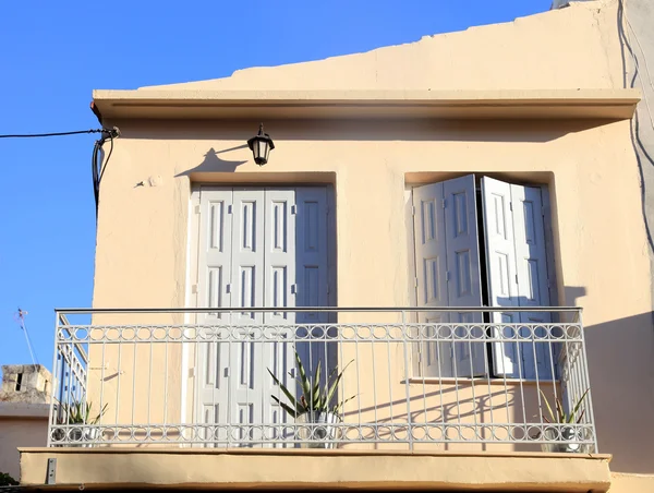 Balcony with shutter windows in an old house, Greece