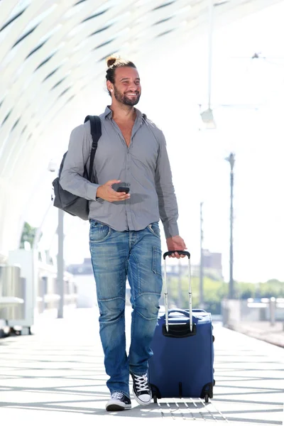 Man walking with luggage on platform