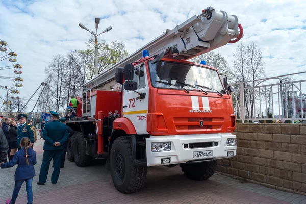 Kamaz fire trucks with ladders at the bottom of a firefighter in