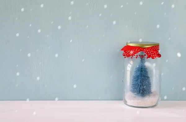 Beautiful mason jar with christmas tree. Snow overlay