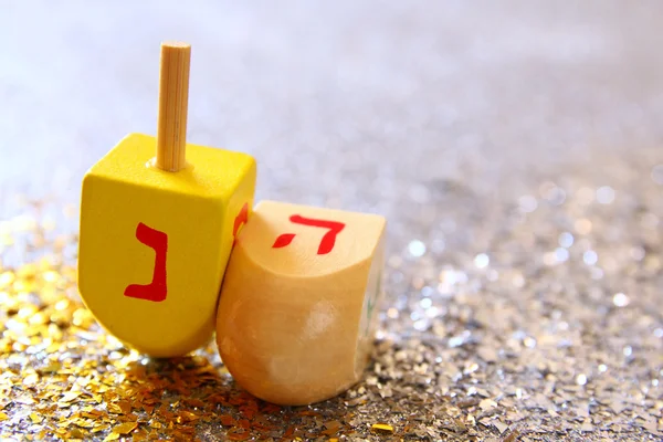 Jewish holiday Hanukkah with wooden dreidel