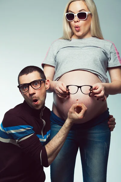 Funny and healthy pregnancy concept. Emotional portrait of happy hipsters