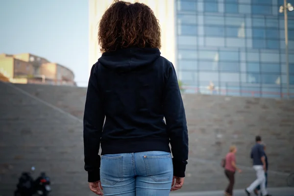 Sad young afro-american girl alone in the city street