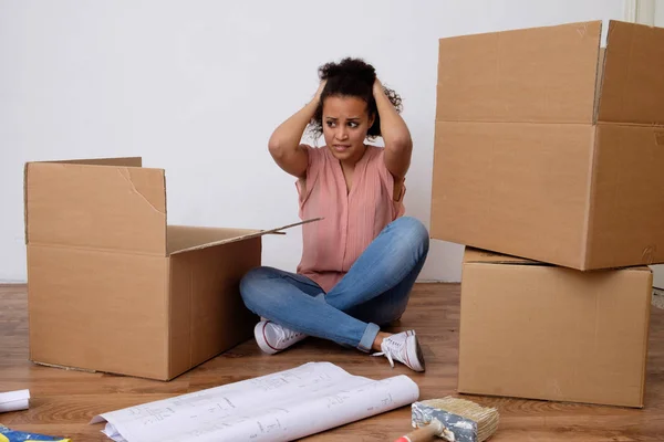 Desperate and tired woman during home relocation