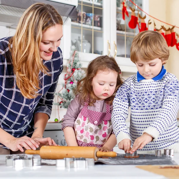 Happy family baking Christmas cookies at home