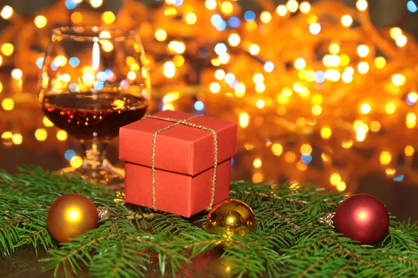 Christmas photo cognac glass and gift box in front of bokeh background