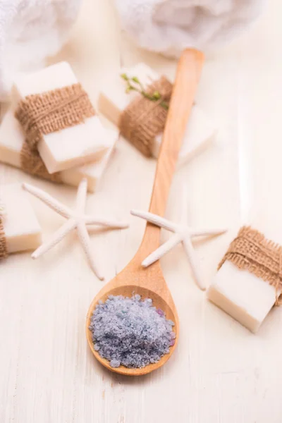 Spa background with bath salts, a towel and a spa soap.