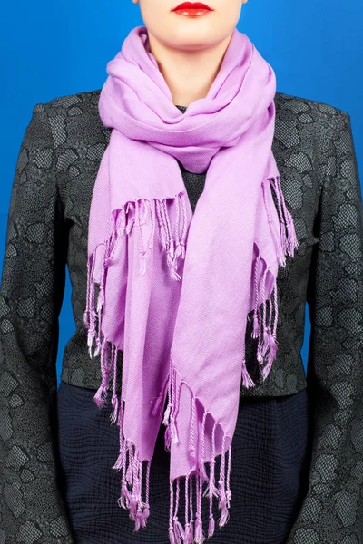 Silk scarf. Lilac silk scarf around her neck isolated on blue background.