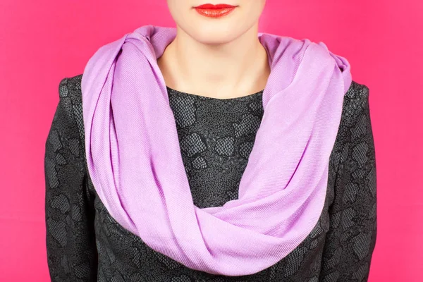 Silk scarf. Lilac silk scarf around her neck isolated on pink background.