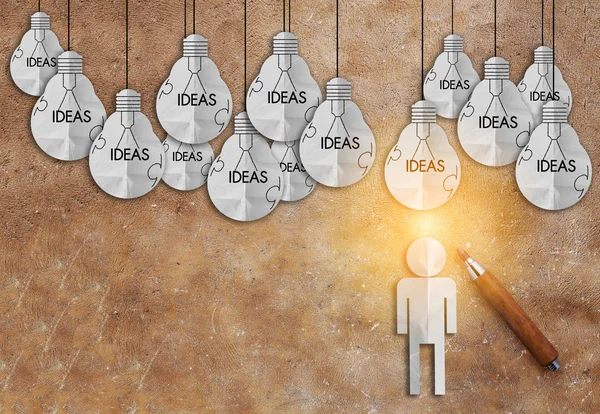 Man paper cut in front of ideas light bulb creativity ideas conc