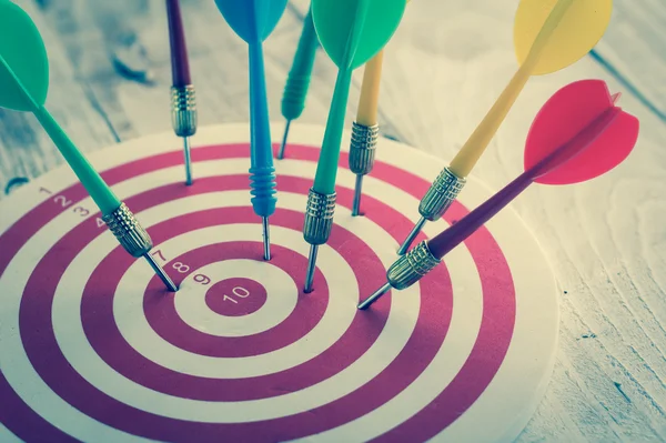 Arrows dart hitting the center of a target, success business con