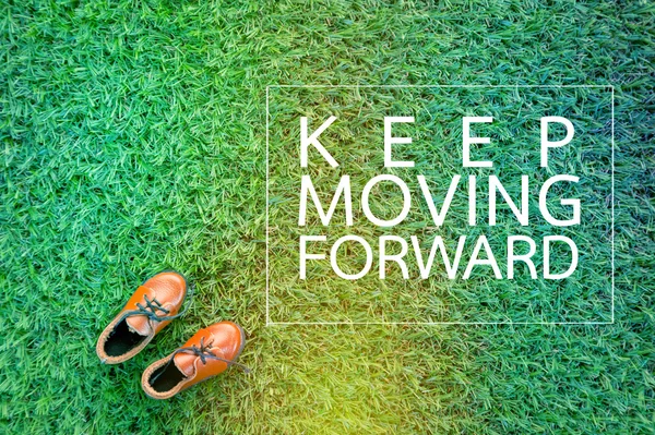 MOVING FORWARD concept with show on grass field.jpg