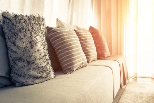 Part of sofa in sunny day and white curtain