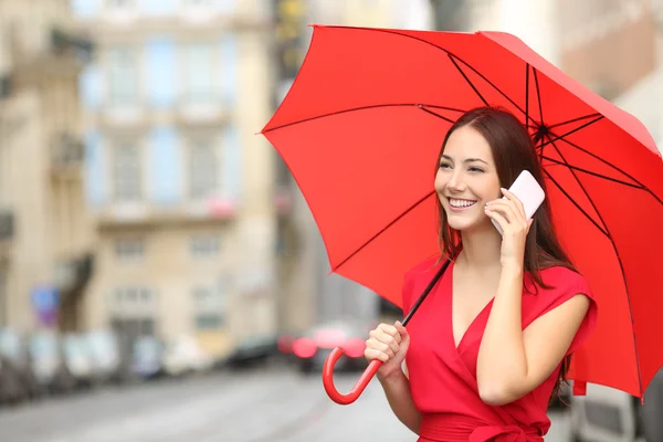 Woman in red talking on a smart phone