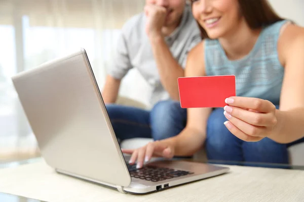 Couple buying online with bank card