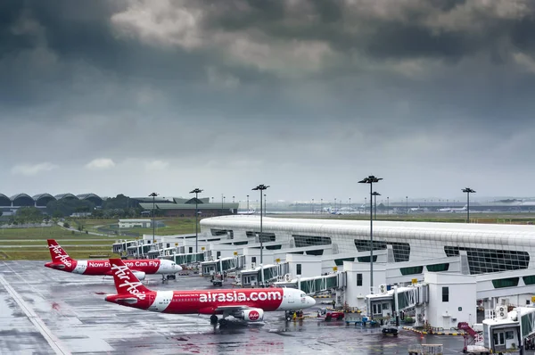 AirAsia Terminal in Kuala Lumpur Airport and storm clouds landscape.