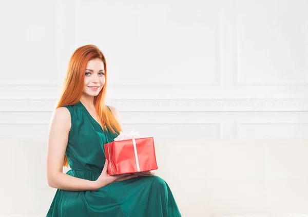 Young woman holding red present