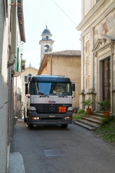 Gas truck on narrow streets at Castelrotto on Switzerland