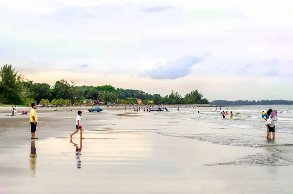 BLACK STONE BEACH, KUANTAN, PAHANG - 1 JUNE 2013 - Nice view of people playing and swimming near the beach. Black Stone Beach located at Kuantan, Pahang, Malaysia.