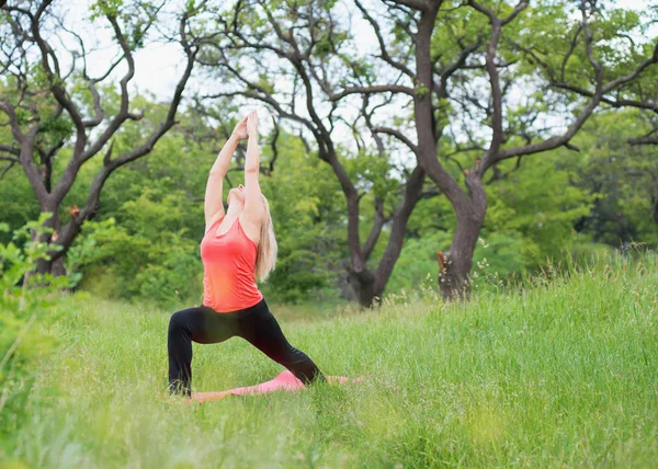 Girl practicing yoga in the park