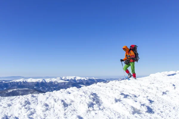 Winter hiking.Winter hiking in the mountains on snowshoes with a backpack and tent