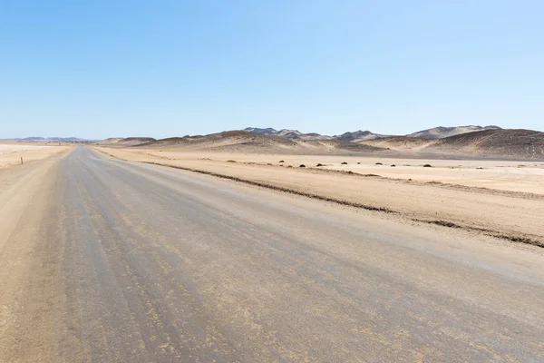 Salt road crossing the Namib desert, in the majestic Namib Naukluft National Park, best travel destination in Namibia, Africa. From Walvis Bay to Swakopmund, Henties Bay and the Skeleton Coast.