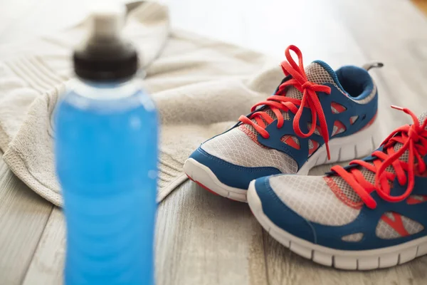 Sport shoes with energy drink and towel