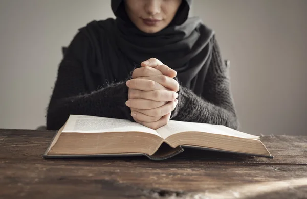 Muslim woman reading holy islamic book koran