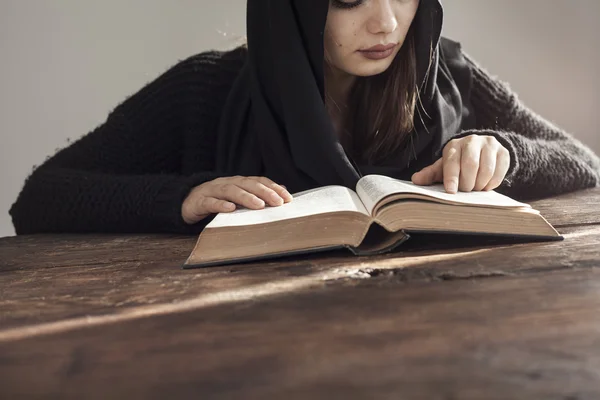 Muslim woman reading holy islamic book koran