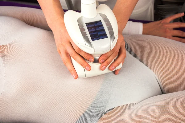 Female body in a white suit having anti cellulite massage