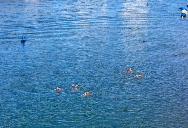 People swimming in the Rhine river in Basel, Switzerland