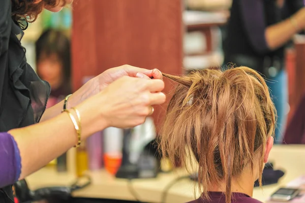 Hairdresser applying hair gel