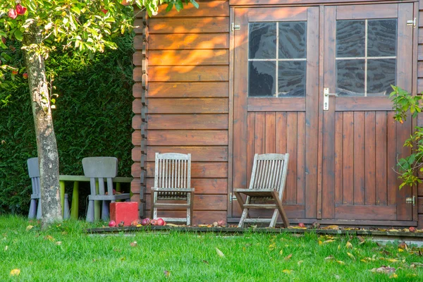 Wooden garden tool shed in a beautiful park