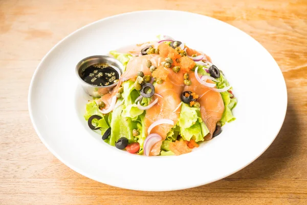 Salmon salad in white plate