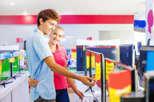 Couple choosing tv in shop