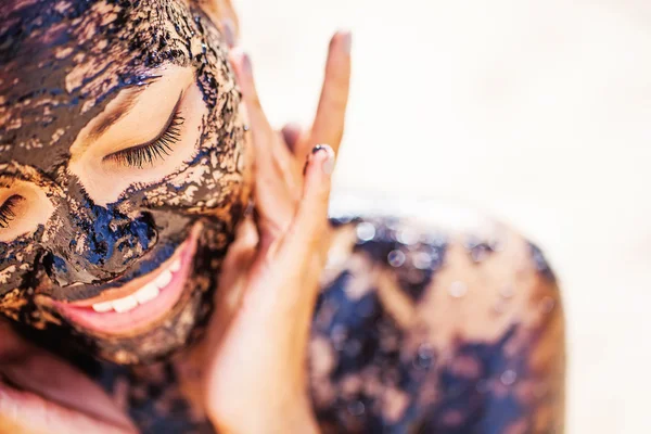 Asian girl applying chocolate mask