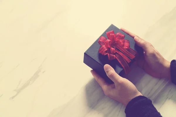 Gift giving,man hand holding a gift box in a gesture of giving o