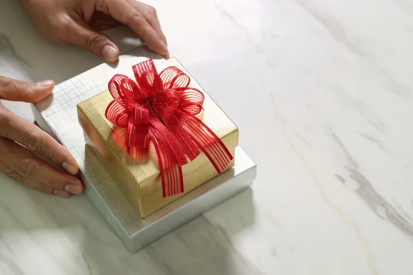 Gift giving,man hand holding a gift box in a gesture of giving o