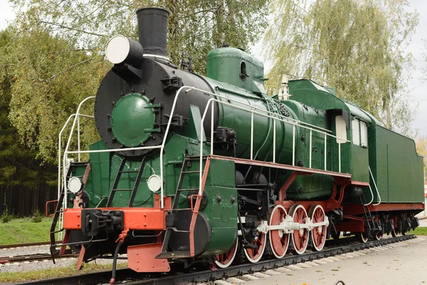 Side view of old green, steam locomotive