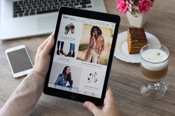 Woman holding iPad Pro with Internet shopping service Amazon